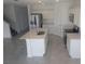Modern kitchen featuring stainless steel appliances and a kitchen island with a sink at 5793 Gingham Dr, Kissimmee, FL 34758