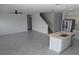 Open-concept living space with tile flooring and staircase, perfect for modern living at 5793 Gingham Dr, Kissimmee, FL 34758