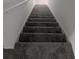 Carpeted staircase with white trim leading to the next level at 5793 Gingham Dr, Kissimmee, FL 34758