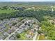 Aerial view of a neighborhood featuring lush greenery, ponds, and well-maintained homes at 6528 Shepherd Oaks Pass, Lakeland, FL 33811