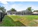 Large backyard featuring a screened-in pool, and space for outdoor activities, all within a private setting at 6528 Shepherd Oaks Pass, Lakeland, FL 33811