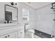 Modern bathroom featuring a white vanity and a walk-in shower with black accents at 6528 Shepherd Oaks Pass, Lakeland, FL 33811