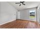 Bright bedroom featuring a ceiling fan, wood floors, and a window at 6528 Shepherd Oaks Pass, Lakeland, FL 33811