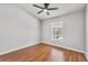 Bedroom with hardwood floors, ceiling fan, and window with screened in porch view at 6528 Shepherd Oaks Pass, Lakeland, FL 33811