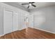 Bedroom with hardwood floors, closet, and ceiling fan at 6528 Shepherd Oaks Pass, Lakeland, FL 33811