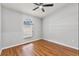 Bedroom with hardwood floors, ceiling fan, and natural light at 6528 Shepherd Oaks Pass, Lakeland, FL 33811