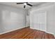 Bedroom featuring hardwood floors, a ceiling fan, and a closet at 6528 Shepherd Oaks Pass, Lakeland, FL 33811