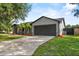 Charming single-story home featuring well-maintained lawn, two-car garage, and beautiful landscaping at 6528 Shepherd Oaks Pass, Lakeland, FL 33811