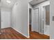 Hallway leading to a bathroom featuring hardwood floors at 6528 Shepherd Oaks Pass, Lakeland, FL 33811