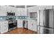 Bright kitchen with stainless appliances, white cabinets, and unique blue backsplash at 6528 Shepherd Oaks Pass, Lakeland, FL 33811