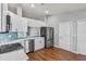 Bright kitchen with stainless appliances, white cabinets, and hardwood flooring at 6528 Shepherd Oaks Pass, Lakeland, FL 33811