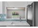 Kitchen sink with stainless faucet and view of the pool area at 6528 Shepherd Oaks Pass, Lakeland, FL 33811