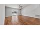 Spacious living room with hardwood floors and access to the screened in pool at 6528 Shepherd Oaks Pass, Lakeland, FL 33811