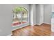 Bright room showcasing new wood floors and natural light, with views of palm trees at 6528 Shepherd Oaks Pass, Lakeland, FL 33811