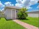 Backyard features a manicured lawn, lush landscaping and a brick pathway at 7266 Desert Mandarin St, Winter Garden, FL 34787