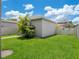 Spacious backyard features manicured grass and a mature tree providing shade at 7266 Desert Mandarin St, Winter Garden, FL 34787