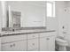 Bright bathroom features a granite countertop, white cabinetry and shower-tub combination at 7266 Desert Mandarin St, Winter Garden, FL 34787