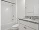 Clean bathroom with a tub and shower combination, granite countertop, and white cabinets at 7266 Desert Mandarin St, Winter Garden, FL 34787