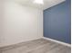 Cozy bedroom with blue accent wall and light wood flooring, ready for personalization at 7266 Desert Mandarin St, Winter Garden, FL 34787