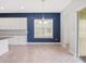 Open dining area adjacent to the kitchen, featuring modern lighting and neutral decor at 7266 Desert Mandarin St, Winter Garden, FL 34787