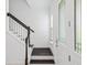 Entryway with stairs, wood floors, and a front door with decorative glass panels at 7266 Desert Mandarin St, Winter Garden, FL 34787