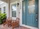 Inviting front porch featuring seating, a stylish front door, and address numbers at 7266 Desert Mandarin St, Winter Garden, FL 34787