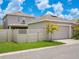 Detached two-car garage with lush landscaping and partial view of the backyard at 7266 Desert Mandarin St, Winter Garden, FL 34787