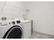 Convenient laundry room with washer, dryer, utility sink and wire shelving at 7266 Desert Mandarin St, Winter Garden, FL 34787