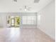 Bright living room with tile floors, large windows, and sliding glass doors to the lanai at 7266 Desert Mandarin St, Winter Garden, FL 34787