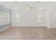 Spacious living room with tile floors, ceiling fan, and large windows with bright light at 7266 Desert Mandarin St, Winter Garden, FL 34787