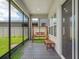 Covered porch features a wooden swing and turf grass looking to the fenced backyard at 7266 Desert Mandarin St, Winter Garden, FL 34787