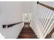 Elegant staircase with dark wood steps and white railings leads to a bright landing at 7266 Desert Mandarin St, Winter Garden, FL 34787