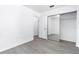 Bright bedroom features gray wood-look floors and mirrored closet at 840 Center Ave # 80, Daytona Beach, FL 32117