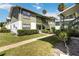 Two-story condo building with green exterior and mature landscaping at 840 Center Ave # 80, Daytona Beach, FL 32117
