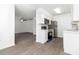 Modern kitchen features stainless steel appliances, white cabinets, and new vinyl flooring at 840 Center Ave # 80, Daytona Beach, FL 32117