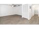 A spacious living room featuring luxury vinyl plank flooring and a large closet at 840 Center Ave # 80, Daytona Beach, FL 32117
