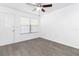 Bright living room featuring a ceiling fan, wood-look flooring, and a window for natural light at 840 Center Ave # 80, Daytona Beach, FL 32117