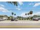 Exterior of two-story condos with palm trees and a parking lot; unit parking available at 840 Center Ave # 80, Daytona Beach, FL 32117