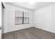 Bright room featuring wood-look flooring and a window with blinds for natural light at 840 Center Ave # 80, Daytona Beach, FL 32117