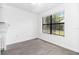 Bright room featuring wood-look flooring and a large window for natural light at 840 Center Ave # 80, Daytona Beach, FL 32117