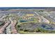 Panoramic aerial perspective of the community featuring houses and lakes set against a backdrop of lush greenery and expansive landscape at 8990 Ace Loop, Champions Gate, FL 33896