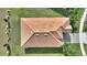 An aerial view shows a terracotta tiled roof on this lovely home, surrounded by green lawns at 8990 Ace Loop, Champions Gate, FL 33896
