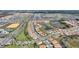 Panoramic aerial view displays residences near lakes, golf courses, neighborhood pool and well-manicured landscapes at 8990 Ace Loop, Champions Gate, FL 33896