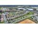 An aerial view showcases the neighborhood's layout, highlighting the home's proximity to green spaces and water features at 8990 Ace Loop, Champions Gate, FL 33896