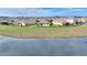 Aerial view of houses bordering a tranquil pond, offering stunning community views at 8990 Ace Loop, Champions Gate, FL 33896