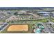 High-angle aerial photo of residences surrounding lakes, as well as a neighborhood pool, and a recreational area at 8990 Ace Loop, Champions Gate, FL 33896