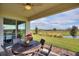 Back porch with a table and chairs overlooking the water at 8990 Ace Loop, Champions Gate, FL 33896