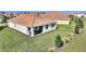 Home's backyard featuring green grass and an outdoor seating area on the patio at 8990 Ace Loop, Champions Gate, FL 33896