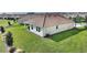 Home featuring a well-maintained lawn, an AC unit, and a tile roof at 8990 Ace Loop, Champions Gate, FL 33896