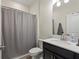 Clean bathroom with shower, toilet, and vanity with modern fixtures and neutral tones at 8990 Ace Loop, Champions Gate, FL 33896